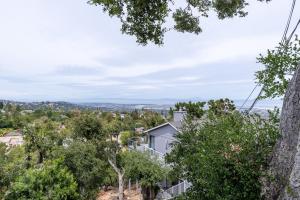 an aerial view of a house surrounded by trees at Serenity Sophistication and Stunning Views in Emerald Lake Hills