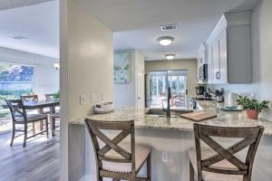 a kitchen and living room with a counter and chairs at Family-Friendly Home Near Destin Beaches in Niceville