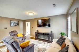a living room with two chairs and a fireplace at Browns Summit Vacation Rental with Fire Pit! in Monticello