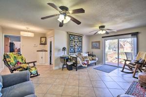 a living room with a couch and a ceiling fan at Spacious Chesapeake Home with Pool Table! in Chesapeake