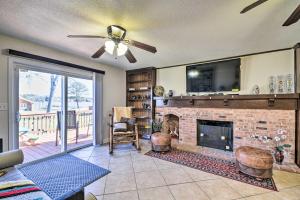 a living room with a fireplace and a tv at Spacious Chesapeake Home with Pool Table! in Chesapeake