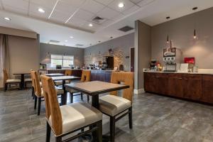 a restaurant with tables and chairs and a counter at Best Western Plus The Hammondsport Hotel in Hammondsport