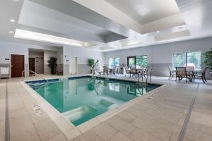 a swimming pool with blue water in a building at Best Western Plus The Hammondsport Hotel in Hammondsport