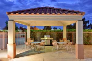 a gazebo with tables and chairs on a patio at Sonesta Simply Suites Baltimore BWI Airport in Linthicum Heights