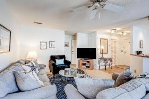 a living room with two couches and a tv at Edisto Bliss in Edisto Island