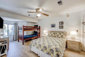 a bedroom with a bed and a crib in it at Edisto Bliss in Edisto Island