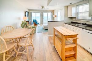 a kitchen and dining room with a table and chairs at Murrells Inlet Condo on Garden City Beach! in Myrtle Beach