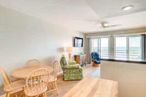 a dining room and living room with a table and chairs at Murrells Inlet Condo on Garden City Beach! in Myrtle Beach
