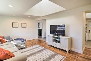 a living room with a couch and a flat screen tv at Spacious Murray Home Near Ski Resorts! in Murray