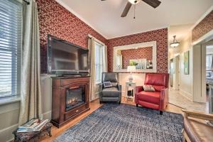 a living room with a fireplace and a tv at Quaint Home with Porch in Downtown Waynesville! in Waynesville