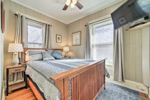 a bedroom with a bed and a flat screen tv at Quaint Home with Porch in Downtown Waynesville! in Waynesville