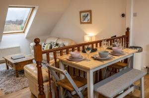 a dining room with a wooden table and chairs at Achintee Cottages No 2 in Fort William