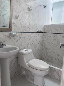 biała łazienka z toaletą i umywalką w obiekcie Hotel Casa Blanca Huacariz w mieście Cajamarca
