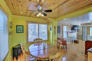 a dining room with a table and a ceiling fan at Charming Lake Ripley Cottage with Water View! in Cambridge
