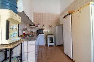 a kitchen with white appliances and a white refrigerator at Casa em Porto, piscina e 5 qrts in Porto De Galinhas