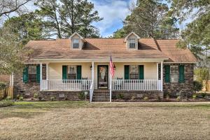 een huis met een vlag op de veranda bij Lakeside Happiness Home on Lake Moultrie! in Moncks Corner