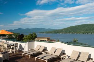 a row of chairs on a deck with a view of a lake at Courtyard by Marriott Lake George in Lake George