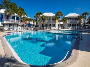 a large pool with blue water in a resort at Bungalows at Seagrove #132 - Kruks Fanta Sea in Seagrove Beach