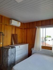 a bedroom with a bed and a window at Casa centro Porto belo in Porto Belo +20 photos