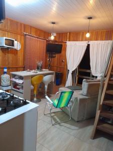 a kitchen and living room with a couch and a table at Casa centro Porto belo in Porto Belo