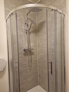 a shower with a glass door in a bathroom at Home Inn in Athlone