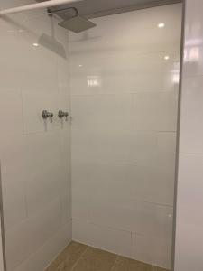 a bathroom with a shower with a glass door at HOBU MONTAÑA in La Calera +83 photos