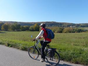 a man riding a bike with a dog on it at Auberge de Trente Pas in Saint-Ferréol-Trente-Pas