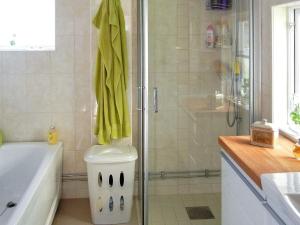 a bathroom with a shower with a toilet and a tub at Holiday home LINKÖPING II in Linköping