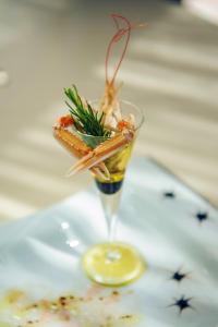 a martini glass with food in it on a table at Hotel Azimut in Sveti Stefan