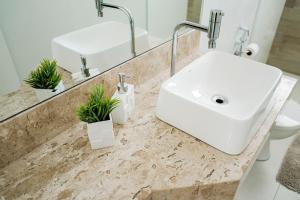 Un baño de Praia da Costa 2 Quartos com Suite Clássico