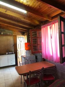 una cucina con tavolo e sedie in una stanza di hermosa cabaña cerca del puerto a San Clemente del Tuyú