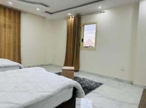 a bedroom with a large bed and a window at primo pyramids inn in Cairo
