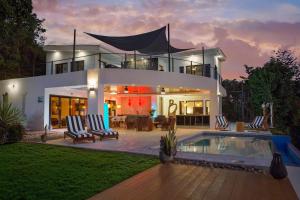 a large house with a swimming pool in front of it at Casa Oli Mar in San Juan del Sur