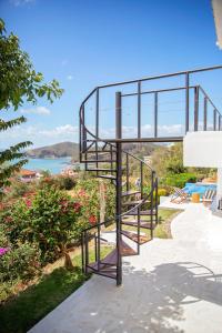 a metal spiral staircase with a view of the water at Casa Oli Mar in San Juan del Sur