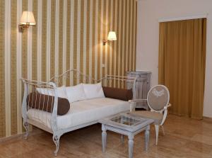 a living room with a couch and a table and a chair at Hotel Azimut in Sveti Stefan