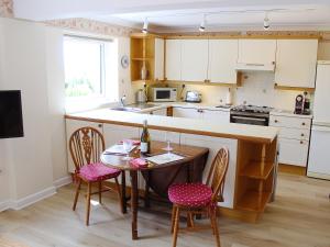a kitchen with a table and chairs and a counter at The Garden Apartment in Saint Columb Major