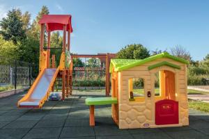 a childrens playground with a slide and a play structure at Comfortable cottages, very close to the sea, G ski in Gąski