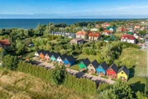 an aerial view of a village with houses and the ocean at Comfortable cottages, very close to the sea, G ski in Gąski