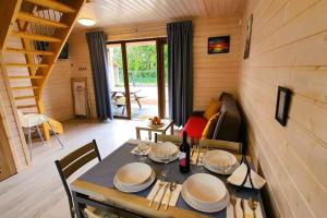 a dining room with a table in a cabin at Comfortable cottages, very close to the sea, G ski in Gąski