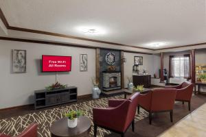 uma sala de estar com televisão na parede em Red Roof Inn & Suites Bloomsburg - Mifflinville em Mifflinville