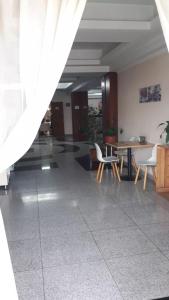 a hallway with a table and chairs in a building at Отель Транзит in Pervomayskīy