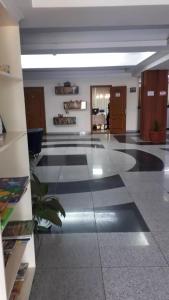 a large lobby with a black and white tile floor at Отель Транзит in Pervomayskīy
