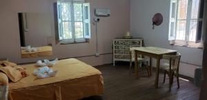 a bedroom with a bed and a table and a desk at El Trébol Casa de Campo in Naicó +7 photos