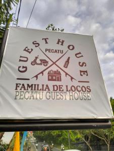 a sign for a family de locos peruvian guest house at Pecatu GuestHouse in Uluwatu