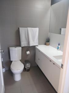 a white bathroom with a toilet and a sink at Entertainment District, Downtown Toronto - 300 Front 1 Bed 1 Bath, City View in Toronto