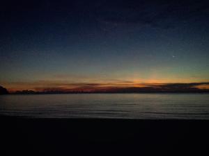 a sunset over a large body of water at Tiongman Scubadive & Lodge in Tioman Island