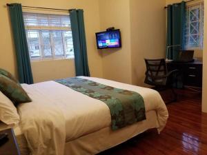 Postel nebo postele na pokoji v ubytování Ridgeview Suites 1 to 3