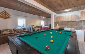 a living room with a pool table at Nice Home In Gornje Ceranje With 2 Bedrooms, Outdoor Swimming Pool And Wifi in Gornje Ceranje