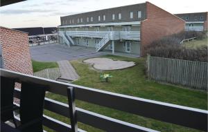 a view from a balcony of a building with a yard at Gorgeous Apartment In Ringkøbing With Wifi in Ringkøbing +10 photos