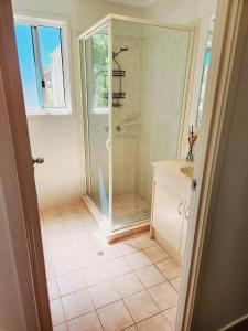 a bathroom with a shower and a sink at Yaringa Cottage, ultimate entertainer! in Encounter Bay